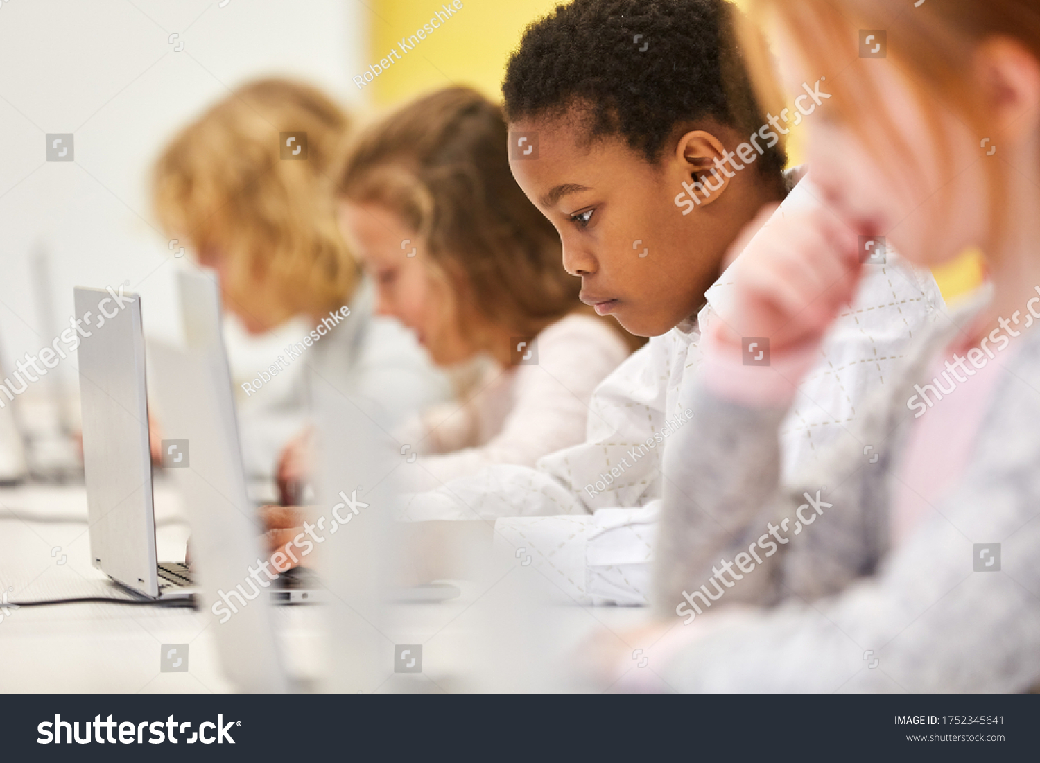 stock-photo-group-of-students-in-a-computer-elementary-school-class-is-learning-with-the-laptop-1752345641